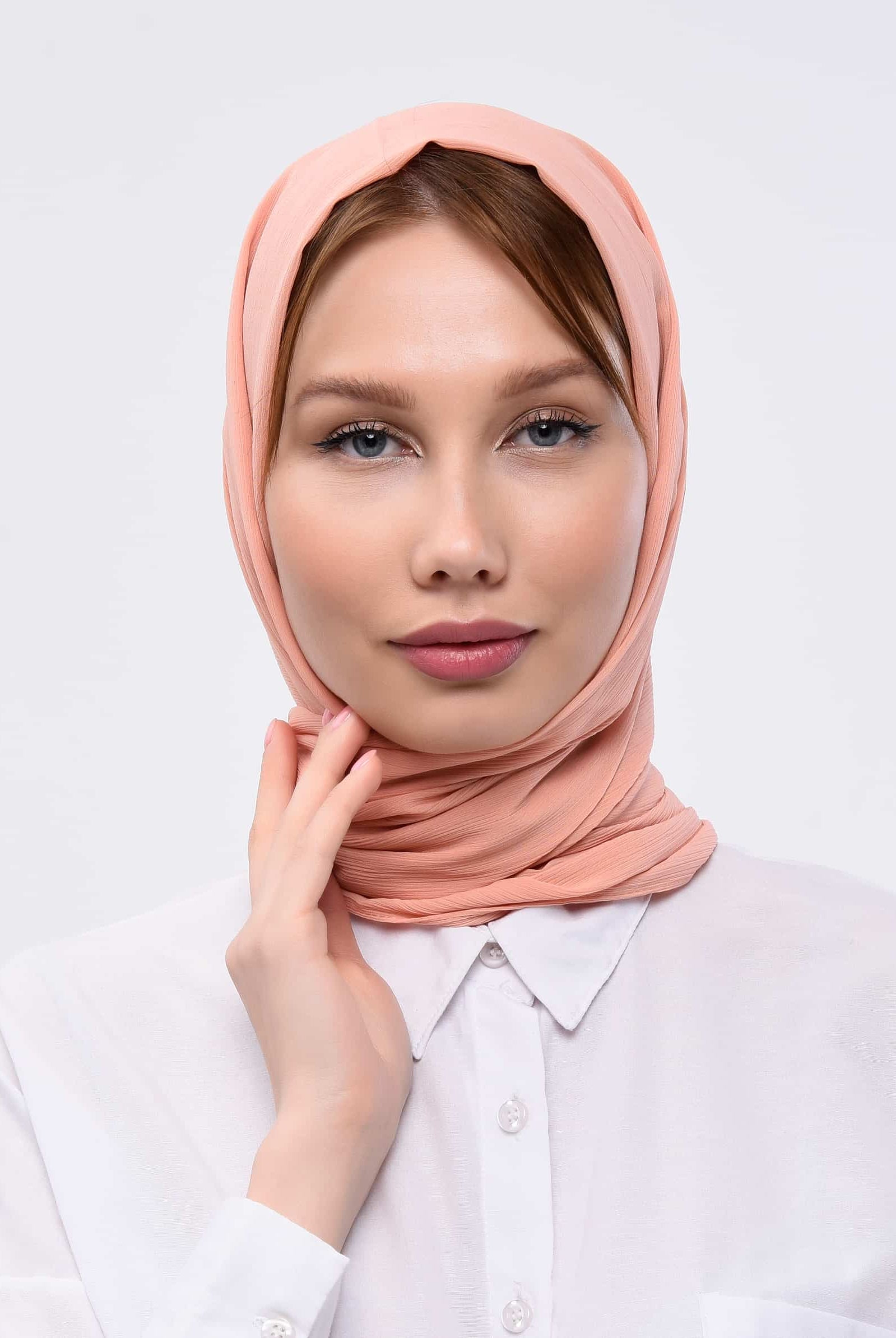 Peach pink scarf has been worn by a lady