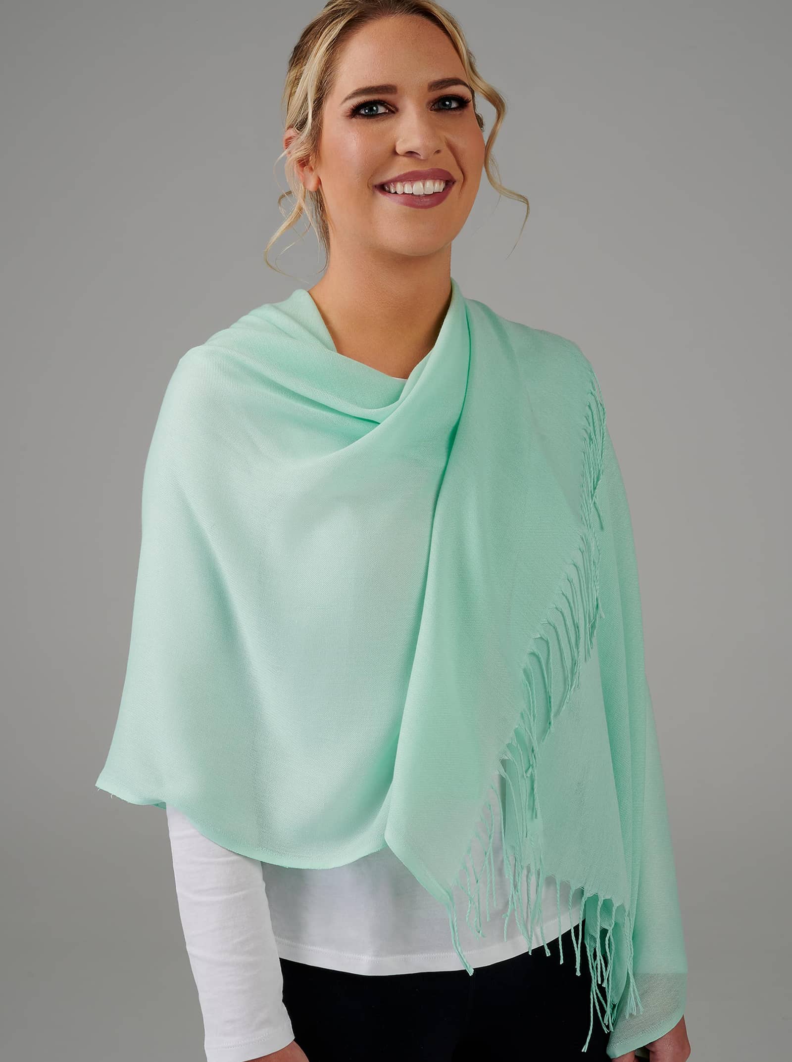 green scarf with tassels