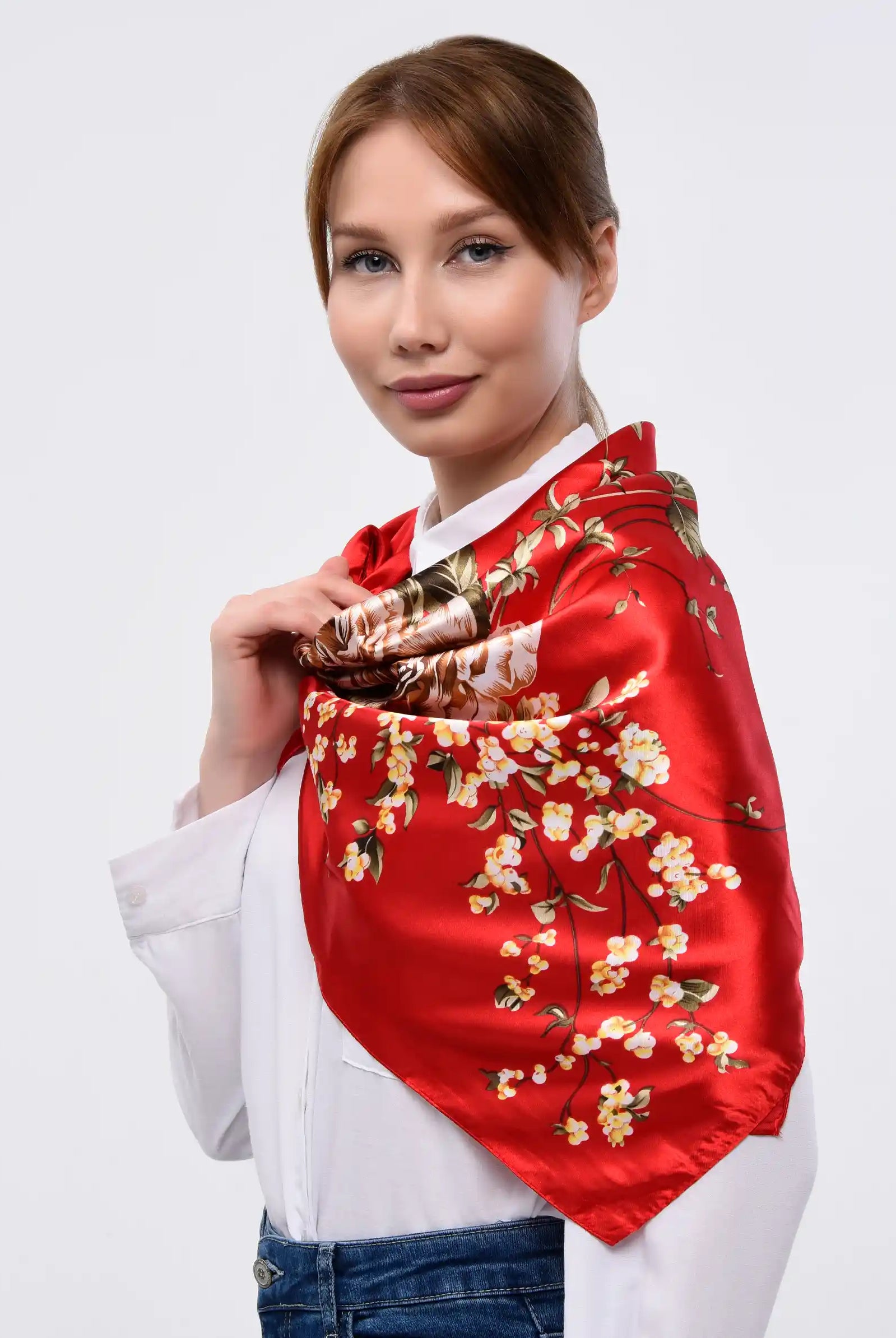 Red floral silk scarf is worn by a lady.