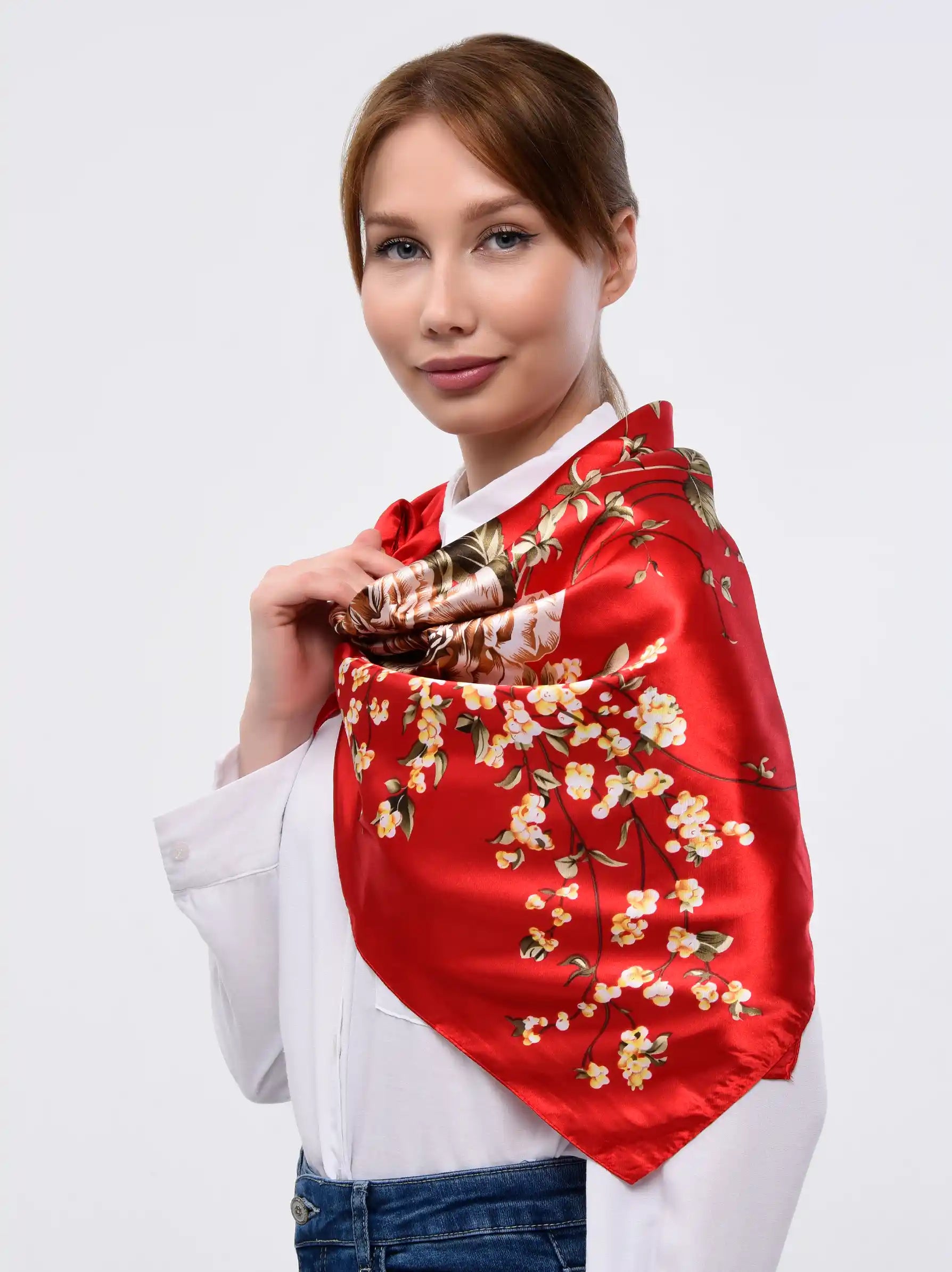 Red floral silk scarf is worn by a lady.