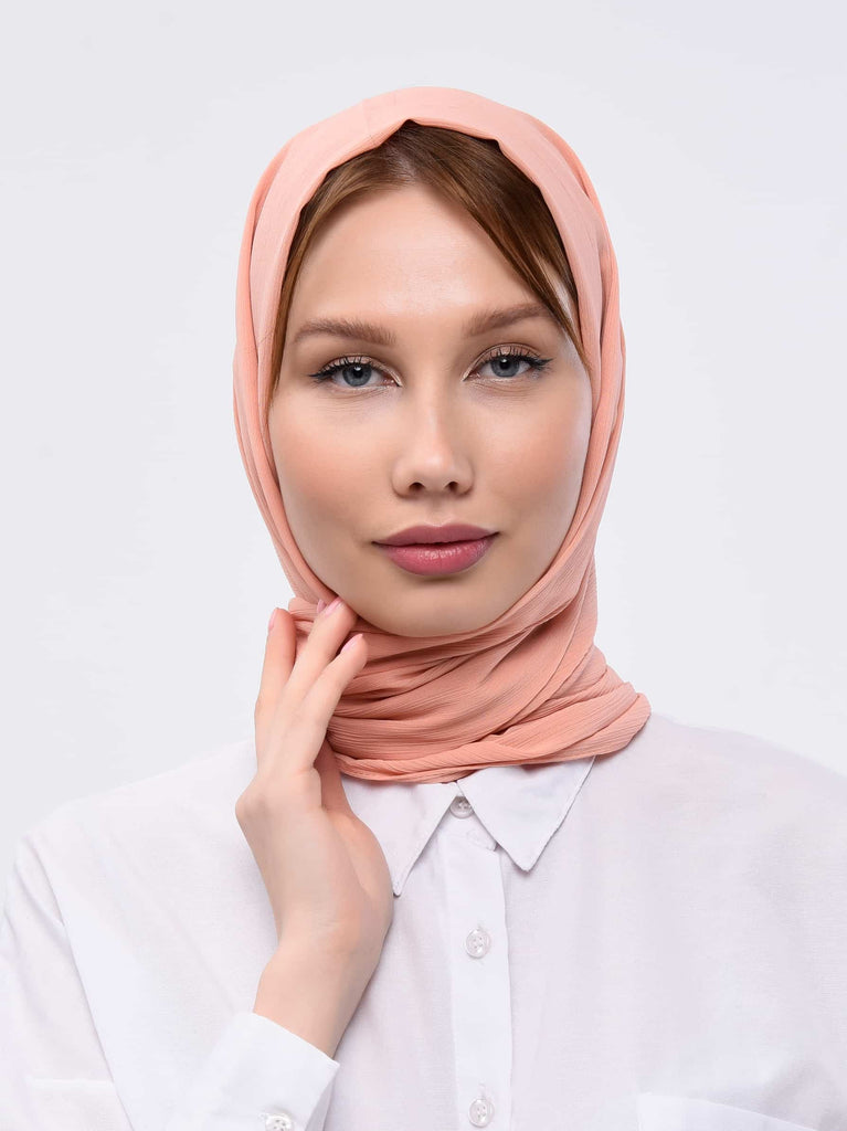 Peach pink scarf has been worn by a lady