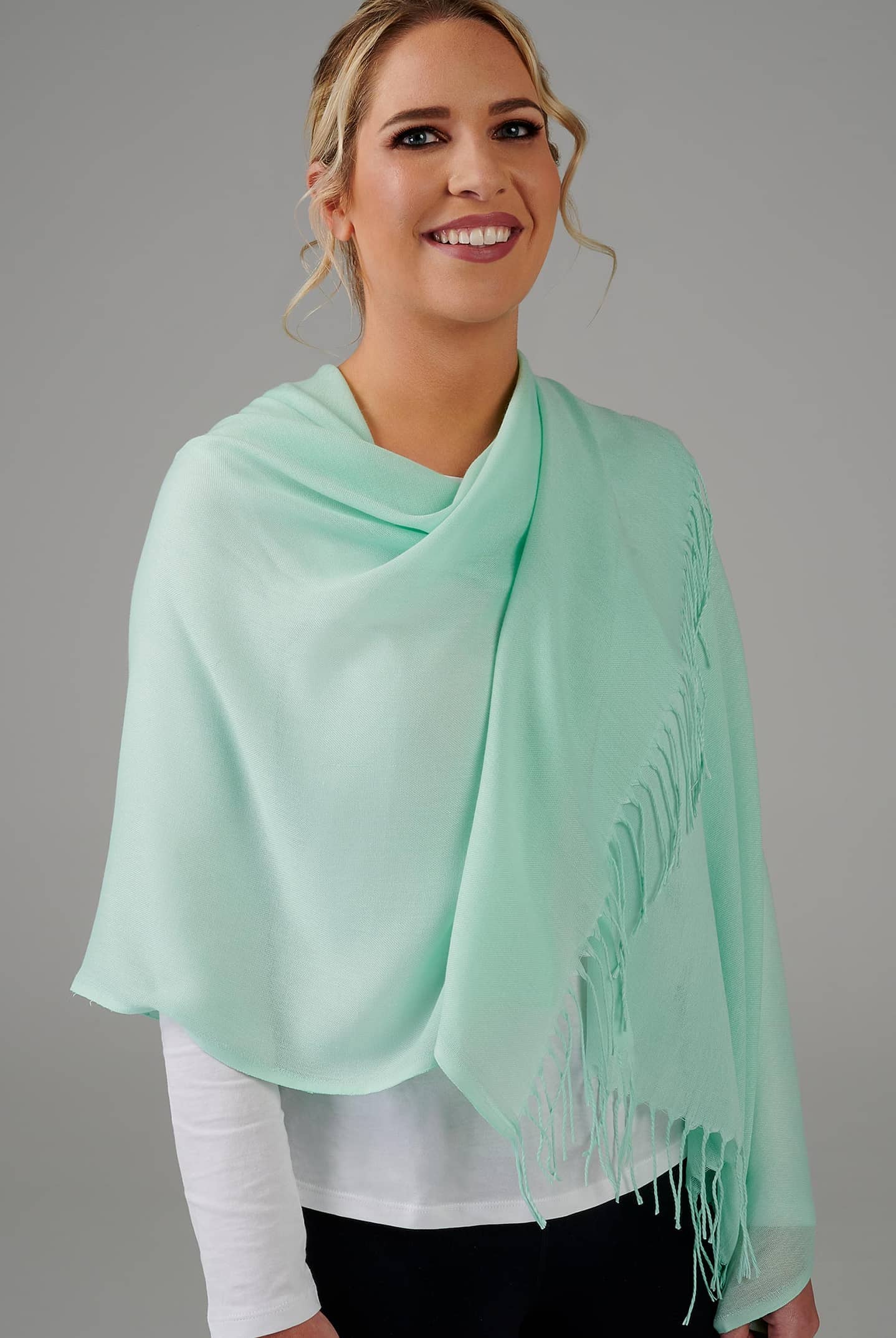green scarf with tassels